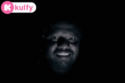 A Man 'S Face Is Visible In The Dark With A Kolfy Logo In The Corner GIF