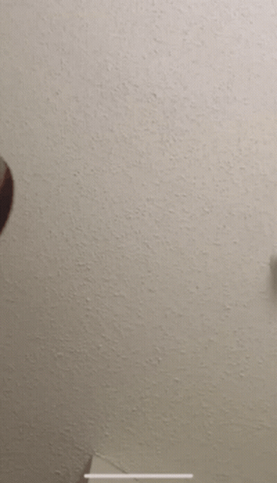 A Man 'S Head Is Against A White Wall GIF