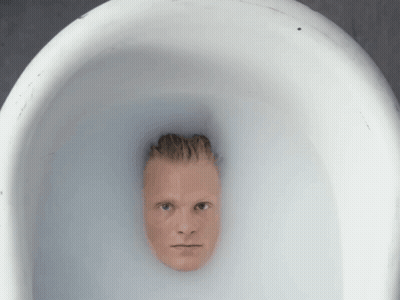 A Man 'S Head Is Sticking Out Of A White Bowl Of Water GIF