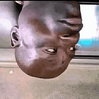 A Man 'S Head Is Upside Down In Front Of A Screen . GIF