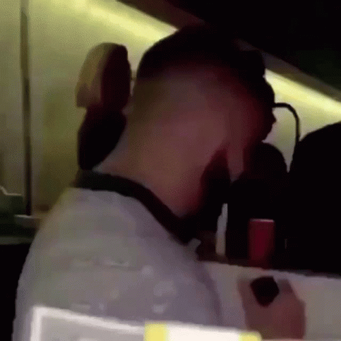 A Man 'S Head Is Visible In A Blurry Photo While Holding A Cell Phone . GIF