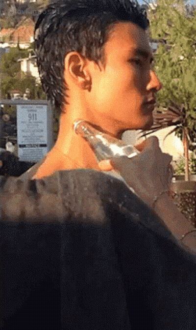 A Man 'S Neck Is Being Massaged In Front Of A Sign That Says 911 On It GIF