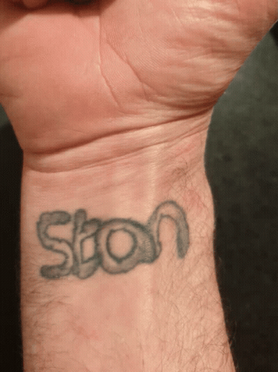 A Man 'S Wrist Has A Tattoo Of The Word Ston On It GIF