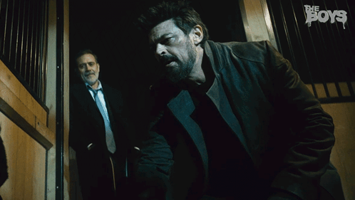 A Man Says Alright Take It Easy While Another Man Stands Behind Him GIF
