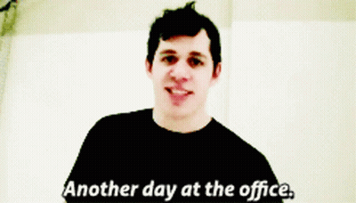 A Man Says " Another Day At The Office " In A Black Shirt GIF