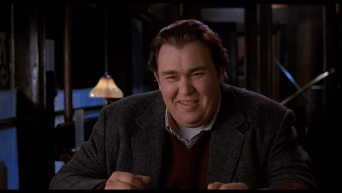 A Man Says Come On Lighten Up Will Ya In A Dark Room GIF