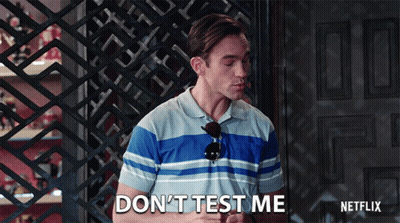 A Man Says " Do N't Test Me " In Front Of A Door GIF