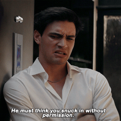 A Man Says He Must Think You Snuck In Without Permission While Leaning Against A Wall GIF