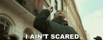 A Man Says I Ain 'T Scared In Front Of A Building GIF