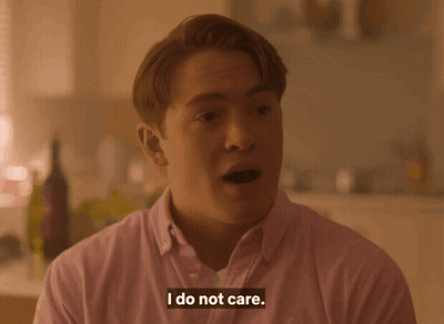 A Man Says I Do Not Care In A Pink Shirt GIF