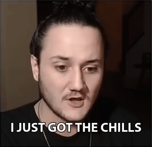A Man Says I Just Got The Chills In Front Of A Black Background GIF