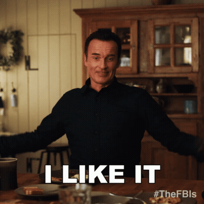 A Man Says I Like It While Standing In Front Of A Table GIF