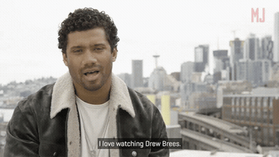 A Man Says I Love Watching Drew Brees In Front Of A City Skyline GIF