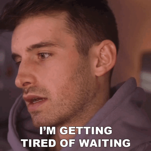 A Man Says I 'M Getting Tired Of Waiting While Wearing A Purple Hoodie GIF