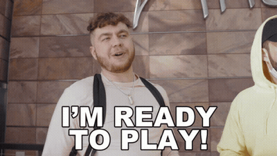 A Man Says I 'M Ready To Play In Front Of A Wooden Wall GIF