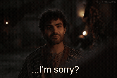 A Man Says I 'M Sorry In Front Of A Dark Background GIF