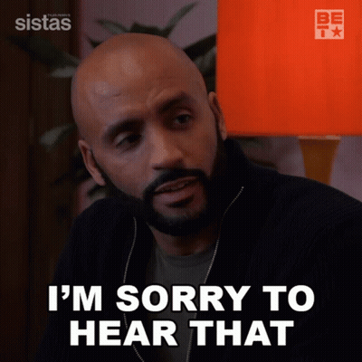 A Man Says I 'M Sorry To Hear That In Front Of An Orange Lamp GIF