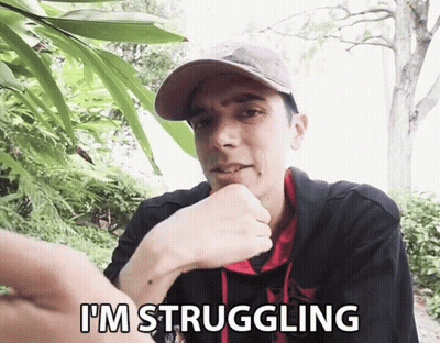 A Man Says I 'M Struggling In Front Of A Tree GIF