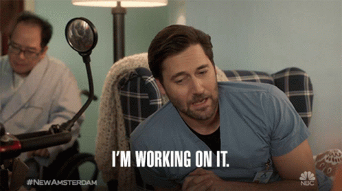 A Man Says I 'M Working On It While Laying On A Couch GIF