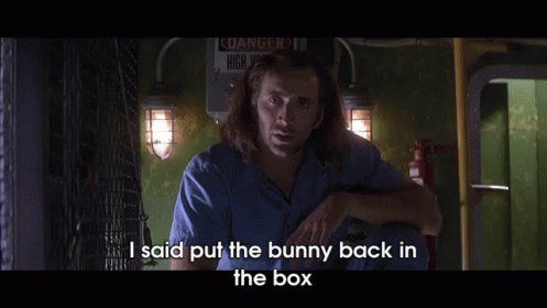 A Man Says I Said Put The Bunny Back In The Box In Front Of A Danger Sign GIF