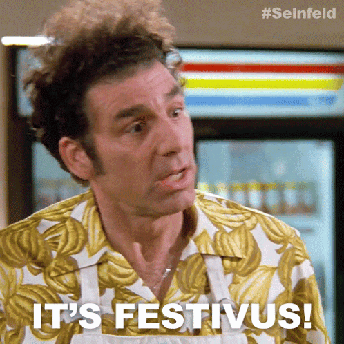 A Man Says It 'S Festivus While Wearing A Banana Print Shirt GIF