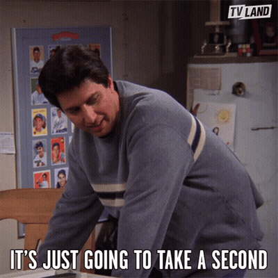 A Man Says It 'S Just Going To Take A Second In Front Of A Tv Land Poster GIF
