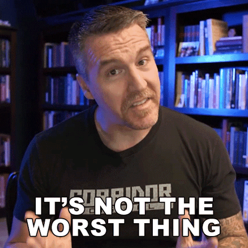 A Man Says " It 'S Not The Worst Thing " In Front Of A Bookshelf GIF