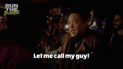 A Man Says " Let Me Call My Guy " In A Crowd GIF
