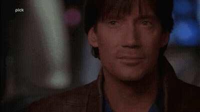 A Man Says " Let 'S Bring It " In Front Of A Dark Background GIF
