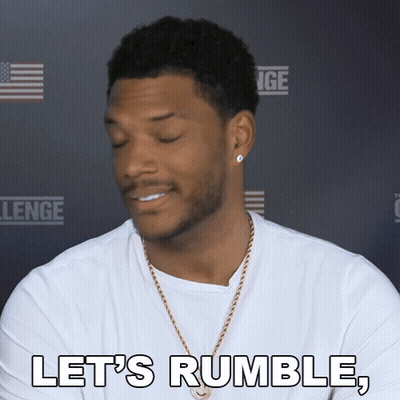 A Man Says Let 'S Rumble In Front Of A Challenge Sign GIF