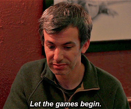 A Man Says Let The Games Begin While Sitting At A Table GIF