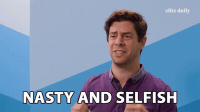 A Man Says " Nasty And Selfish " In Front Of A Blue Wall GIF