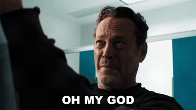 A Man Says Oh My God In Front Of A Blue And White Wall GIF