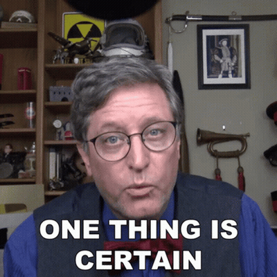 A Man Says One Thing Is Certain In Front Of A Shelf GIF