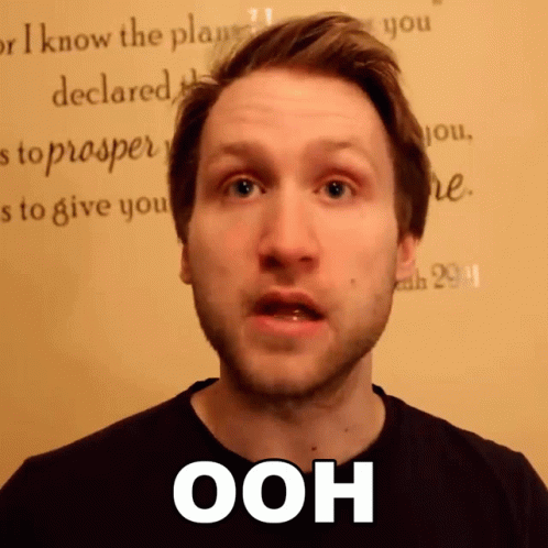 A Man Says Ooh In Front Of A Wall GIF