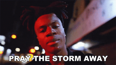 A Man Says Pray The Storm Away While Standing In Front Of A Building GIF