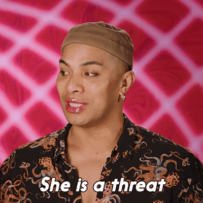 A Man Says She Is A Threat With A Pink Background GIF