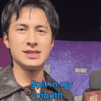 A Man Says " Spit In My Mouth " While Standing In Front Of A Microphone GIF