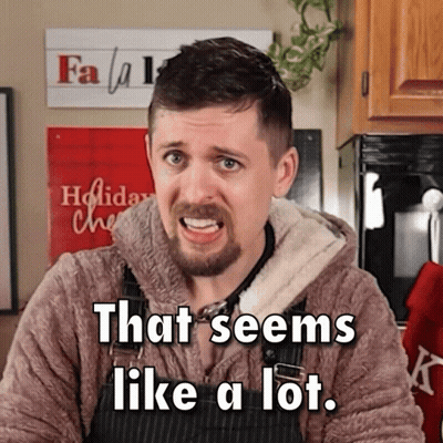 A Man Says That Seems Like A Lot In Front Of A Christmas Sign GIF