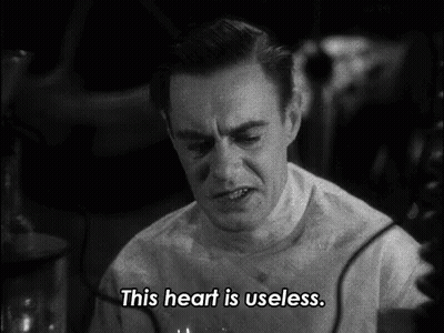 A Man Says " This Heart Is Useless " In A Black And White Scene GIF