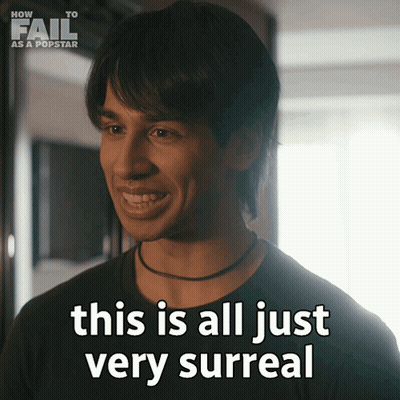 A Man Says " This Is All Just Very Surreal " In Front Of A Sign That Says How To Fail As A Popstar GIF