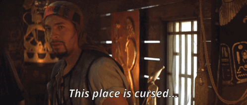 A Man Says This Place Is Cursed In Front Of A Statue GIF