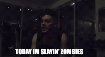 A Man Says " Today Im Slayin ' Zombies " In A Dark Room GIF