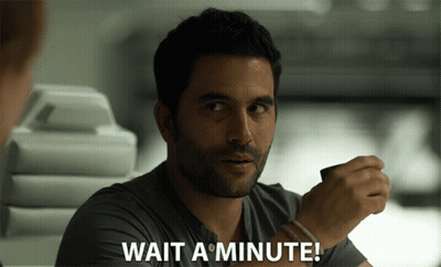A Man Says Wait A Minute While Holding Something GIF