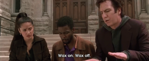 A Man Says Wax On Wax Off In Front Of A Building GIF