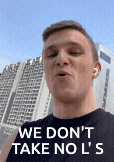 A Man Says " We Don 'T Take No L 'S " In Front Of A Tall Building GIF