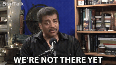 A Man Says We 'Re Not There Yet While Sitting In Front Of A Microphone GIF
