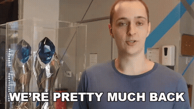 A Man Says We 'Re Pretty Much Back While Standing In Front Of Trophies GIF