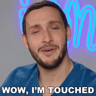 A Man Says Wow I 'M Touched In Front Of A Neon Letter M GIF