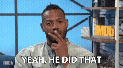 A Man Says Yeah He Did That In Front Of A Shelf With Imdb On It GIF